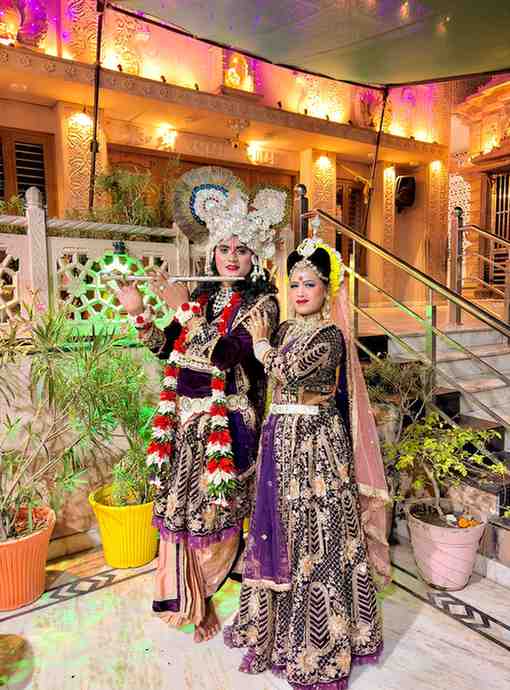 Traditional Indian wedding performers in colorful attire at Taj Kala Group event.